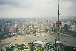 A view from the Jin Mao Tower's Skywalk, showing the Oriental Pearl Tower in Lujiazui and, across the Huangpu River, Shanghai's Bund, Nanjing Road, and the Garden Bridge across Suzhou Creek
