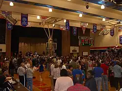 A crowd gathers on the basketball court at Sharp Gymnasium after a men's basketball game between the Houston Baptist Huskies and Bacone Warriors on February 9, 2008.