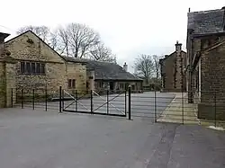 Rear courtyard with stables and outbuildings to the left