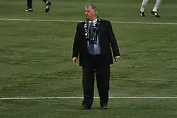 Schmid on the pitch in a suit