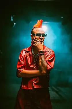 Sir Speedy wearing red leather outfit and sunglasses