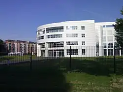 Large, white, four-storey building with a curved facade