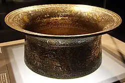 The Baptistère de Saint Louis; by Muhammad ibn al-Zayn; 1320–1340; hammering, engraving, inlay in brass, gold, and silver; 50.2 x 22.2&nbsp;cm