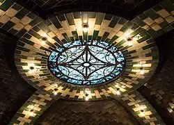 Detail of green-and-white ceiling tiles surrounding the station's skylight