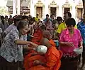 Monks receiving blessing at a temple in Ban Khung Taphao