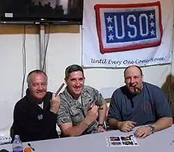 James Gandolfini, The Sopranos co-star Tony Sirico, and a soldier posing for a photograph