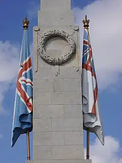 Carved flags either side of an obelisk