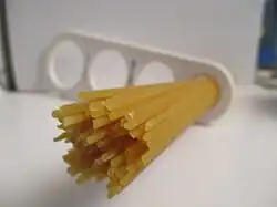 Dried spaghetti measured with a "spaghetti measure". One portion of dried pasta weighs 116&nbsp;g (4+1⁄8&nbsp;oz), twice the amount of one serving on the package (12&nbsp;mm circle or 60&nbsp;g.). The measure can portion out 1, 2, 3 or 4 servings based on the diameter of the circle.