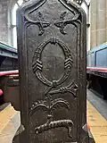 Nave pew end carved with the letter 'Q'