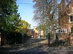 The rear entrance of St Hugh's College, at the northern end of Winchester Road at the junction with Canterbury Road.