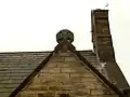 Stone chancel roof cross now on porch gable