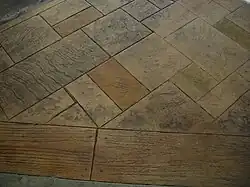 Irregular sized and tiled stamped concrete with a stone and wood-grain like textures