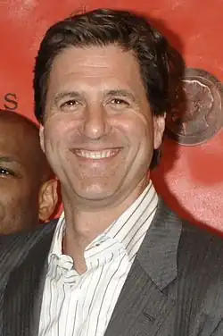 Steven Levitan smiling against a red background at the 69th Peabody Awards