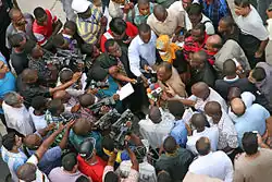 Image 18Photo and broadcast journalists interviewing government official after a building collapse (from Broadcast journalism)