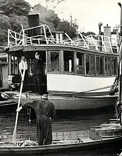 Owner Charles Rosman (wearing braces), on the Rodney after she was refloated