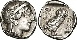 Athenian tetradrachm coin representing the goddess Athena, with on the reverse a little owl and an olive branch. The lettering ΑΘΕ (ATHE[NA]) is visible on the right.