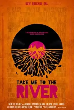 Poster for Take Me to the River: New Orleans, featuring a vinyl record with roots extending downward, symbolizing deep musical heritage. The top of the record showcases a silhouette of the New Orleans skyline. The background is orange with artist names faintly visible, and the title is displayed in bold, vibrant lettering.