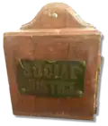 This tzedakah box hung for decades in Temple Sinai, in New Orleans, calling on congregants to support social justice causes.