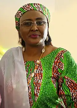 Aisha Buhari wearing Hausa clothes and hijab, which consists of the kallabi matching the dress cloth design, and gyale draped over the shoulder or front