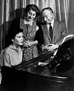 Uncle David and Molly with Rosalie at the piano