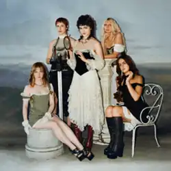 The five band members pose in stylish vintage dresses.