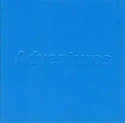 A blue cover with the word "Adventures" embossed.