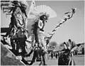 Three Pueblo Indians watching tourists at San Ildefonso Pueblo, New Mexico. Photograph taken by Ansel Adams in 1942.