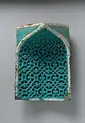 Tile from a Squinch, late 14th century, stone paste carved and glazed.
