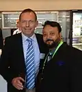 Koch is with Tony Abbott in 2012.