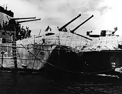 Image 23The light cruiser HMAS&nbsp;Hobart showing torpedo damage inflicted by a Japanese submarine on 20 July 1943. Hobart did not return to service until December 1944. (from History of the Royal Australian Navy)