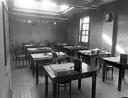 Black-and-white photo of an empty room with desks