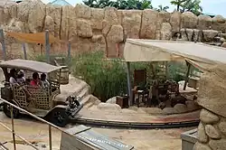 A car approaching an undercover area of theming