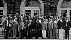 Photograph of the Marine Biological Laboratory trustees standing in front of a building