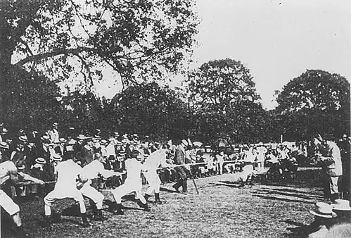 Black and white image of tug of war game