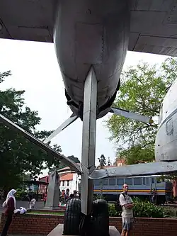 Plane undercarriage, with railway carriage beyond
