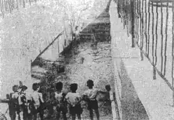 Onlookers observing damage