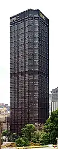a black tower with a triangular floor plan. You can see two of the sides with the acronym "UPMC" sits at the top of each side.