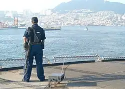 YN3 Tanya Enis stands force protection watch in Pusan harbor as USS Blue Ridge (LCC-19) makes a 2-day port call.