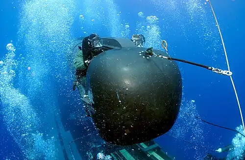 A member of SEAL Delivery Vehicle Team Two prepares to launch one of the team's SEAL Delivery Vehicles from the back of USS&nbsp;Philadelphia on a training exercise. The SDVs are used to carry Navy SEALs from a submerged submarine to enemy targets while staying underwater and undetected.