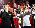 Jessica Hatfield, a vocalist with the United States Navy 7th Fleet Band (left), and Tanya Christensen, a vocalist with Australian Army Band Brisbane singing Waltzing Matilda at a concert.