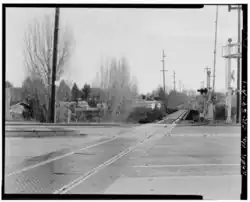 Photograph of a single railway line crossing a road