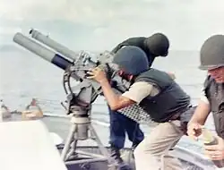 A gun crew on board USCGC&nbsp;Point Comfort&nbsp;(WPB-82317) firing an 81&nbsp;mm mortar during the bombardment of a suspected Viet Cong staging area one mile behind An Thoi in August 1965