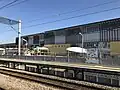 A view from the Kagoshima Main Line platform eastwards across the station forecourt towards the Shinkansen station.