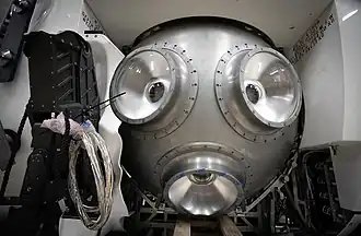 The titanium pressure hull during construction, with the acrylic viewports installed and the manipulator arm partly installed.