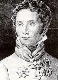 Black and white print shows a clean-shaven man with dark hair. He wears a white military uniform pinned with a number of awards.