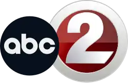 A logo with two different circular elements; a black ABC logo, then the station's main numerical logo, which features a numerical gray-gradient "2" inset into a thick circle of the same color. A contrasting dark red gradient fills in the space between the circle and the "2"