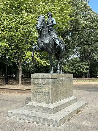 Statue depicting a woman in military attire riding a horse