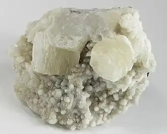 Two sharp pseudohexagonal crystals of witherite on calcite from Hardin County, Illinois (size: 6.4 × 5.4 × 3.4 cm)