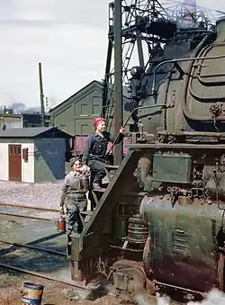 Women wipers of the Chicago and North Western Railroad cleaning one of the giant 4-8-4 "Northern" H-class steam locomotives, Clinton, Iowa, April 1943