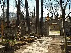 Old Cemetery in Pęksowy Brzyzek with the Church of Our Lady of Częstochowa in the background